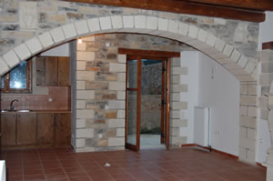 Internal arch between living area and kitchen. Side door to outside kitchen.