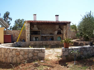 Outdoor kitchen with double oven, space for fridge, gathering circle, stone wall and patio base