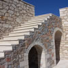 Stone staircase leading to roof terrace. Arched storage areas formed under stairs.