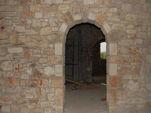 Arched dooway and exposed stonework