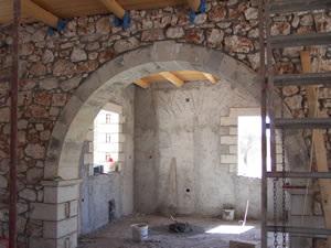 Internal arch with exposed ceiling beams and stonework detail